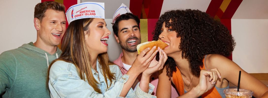 Friends Eating Hot Dogs at American Coney Island Downtown Las Vegas Fast Food
